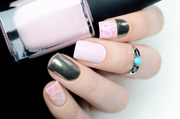 istock Delicate pastel pink manicure with broken glass design on black white background 1196257473