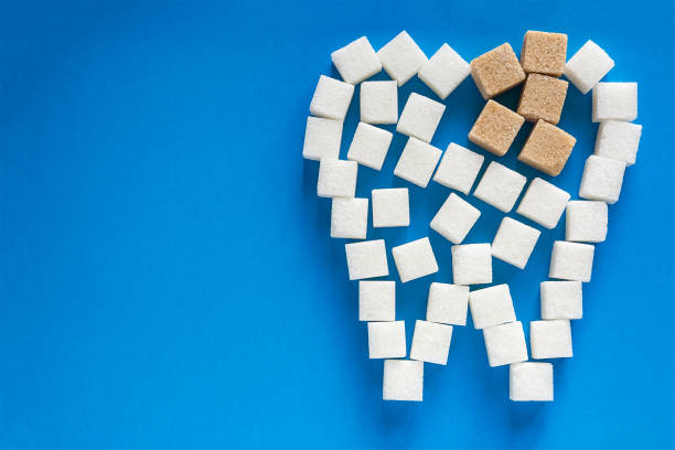 the carious tooth of sugar cubes stock photo