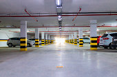 Underground parking garage with various cars.