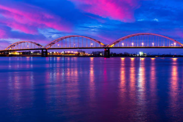 Centennial Bridge over Mississippi River in Rock Island IL and Davenport IA Centennial Bridge over Mississippi River connecting Rock Island, Illinois and Davenport, Iowa during the morning blue hour davenport iowa stock pictures, royalty-free photos & images