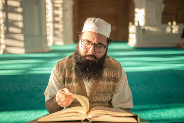 istock Muslim man reading holy book (Qur'an- Qoran) 1196261046