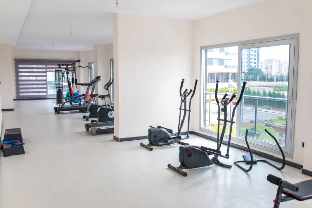 istock Gym interior and exercise equipments. Apartment gym studio saloon. 1196261181