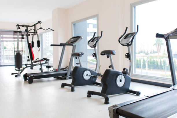 istock Gym interior and exercise equipments. Apartment gym studio saloon. 1196261234