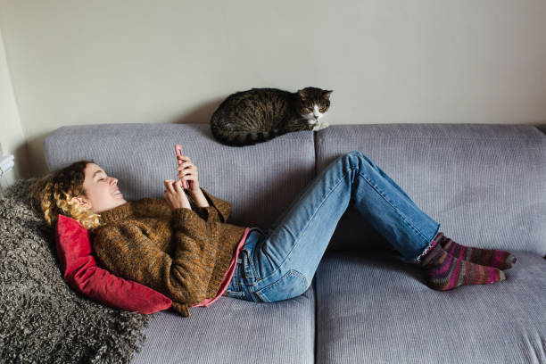 istock Beautiful young woman with her cat 1196262351