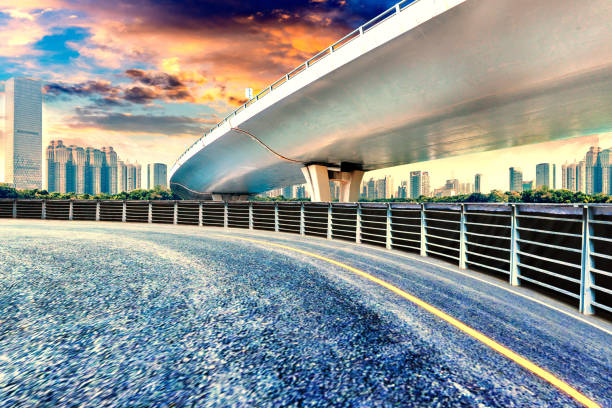 istock Empty asphalt road, overpass and modern urban architecture sunset landscape. 1196263412