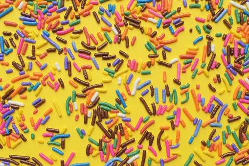 Colorful sprinkles on a yellow background