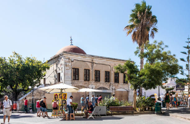 Kos, Greece - September 21st 2019: - People walking past Defterdar mosque in Elefterias Square. This is the centre of Kos town
