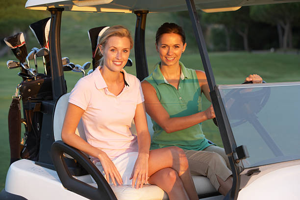 istock Female Golfers Riding In Buggy On Golf Course 119627116