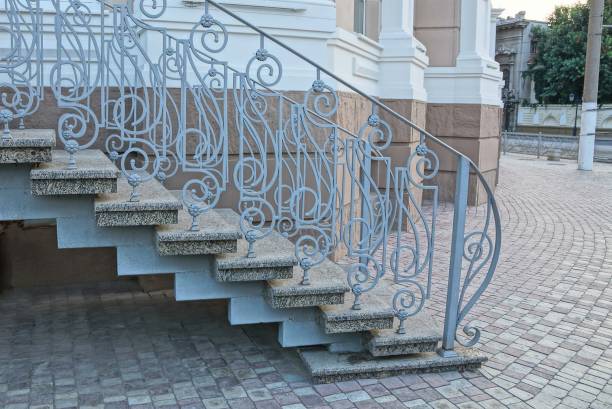 istock gray concrete steps and iron handrails with a forged pattern on the sidewalk near the wal 1196271732