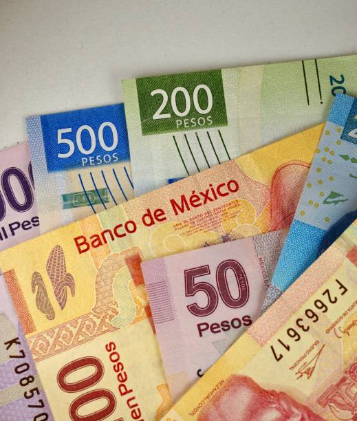 istock Many mexican pesos bills spread randomly over a flat surface 1196274239