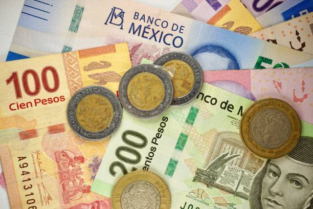 istock Many mexican pesos bills spread randomly over a flat surface 1196274358