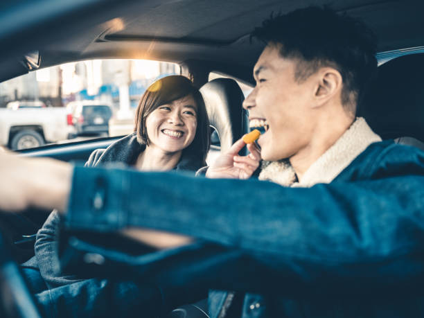 istock Asian couple snacking in the car 1196279499