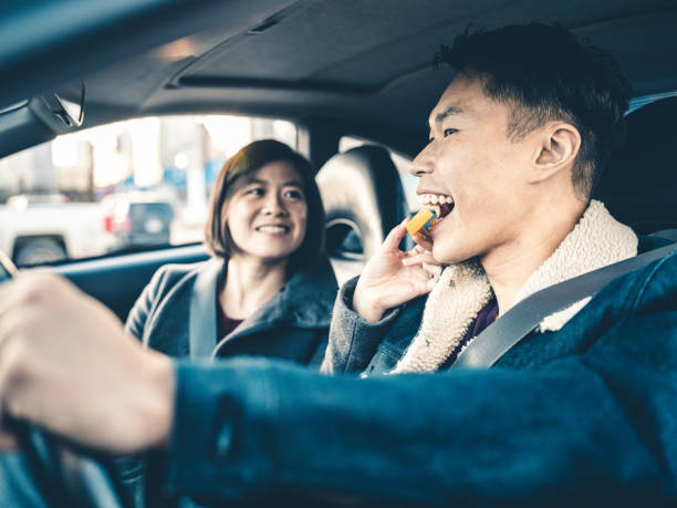 istock Asian couple snacking in the car 1196280853