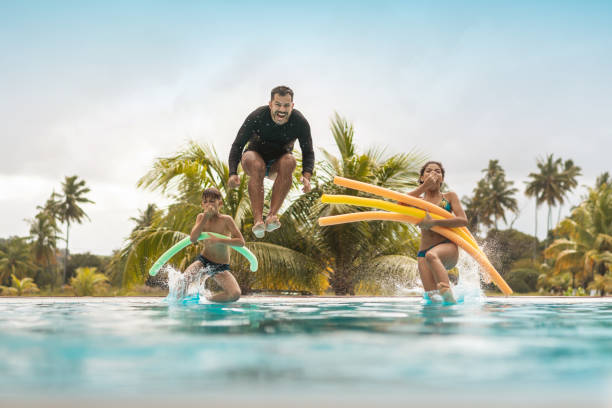 tourists bathing in resort swimming pool - hotel tourist resort luxury tropical climate imagens e fotografias de stock