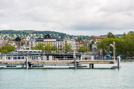 Cruise ship dock at the Lake of Zurich with background of buldings at the lakeshore in Zurich, Switzerland.