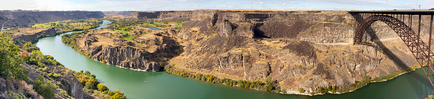 Panorama of the truss arch Perrine Bridge spanning the Snake River Canyon with the Snake River 450 feet below. Twin Falls, Idaho, USA.