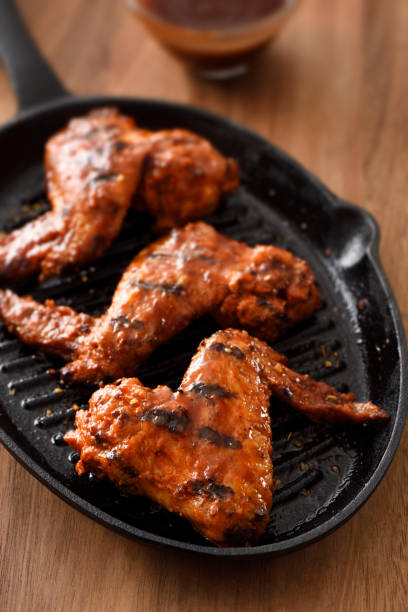 istock Barbecue grilled chicken wings in a griddle 1196298914
