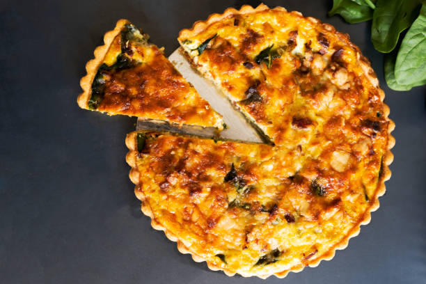 istock top view freshly bake leek bacon spinach quiche on dark background 1196299587