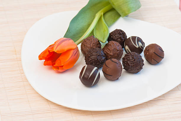 Easter composition with chocolate eggs and bunny on rustic wooden table.