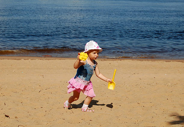 istock baby girl run on the beach 119630468