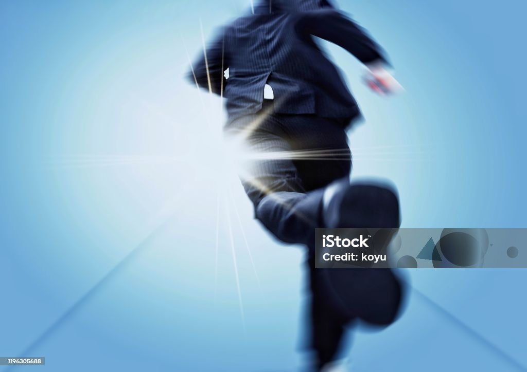 Back view of a businessman running towards a goal Running Stock Photo