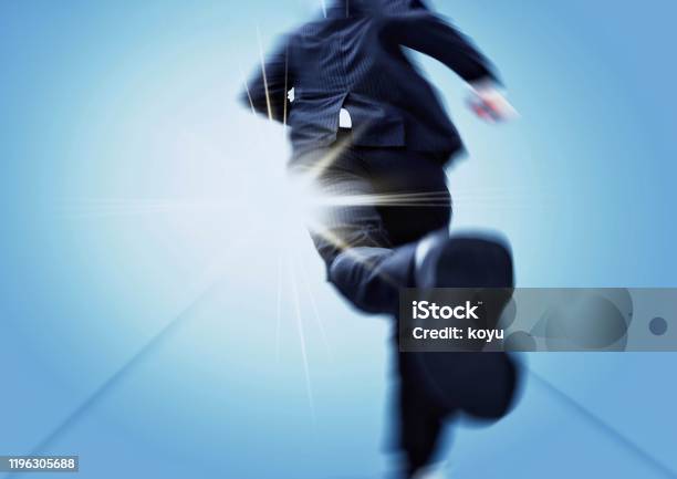 Back View Of A Businessman Running Towards A Goal Stock Photo - Download Image Now - Running, Businessman, Motion