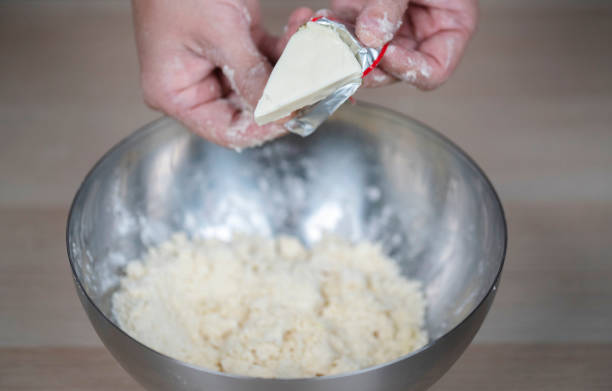 istock putting cream cheese into cake flour 1196305879