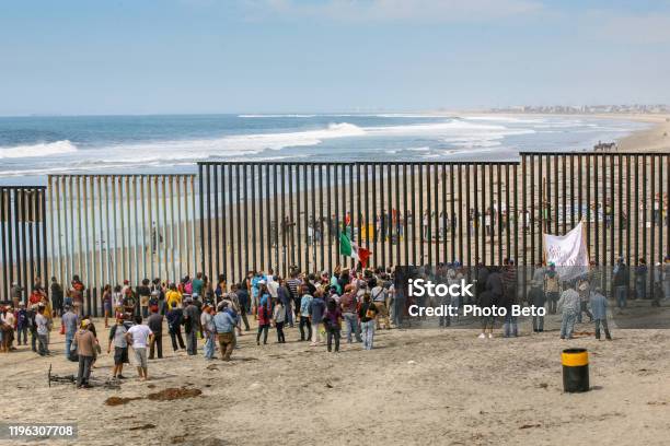 Migrants And Workers Meet Along Both Sides Of The Usmexico Border Wall At Tijuana Beach In Northern Mexico Stock Photo - Download Image Now