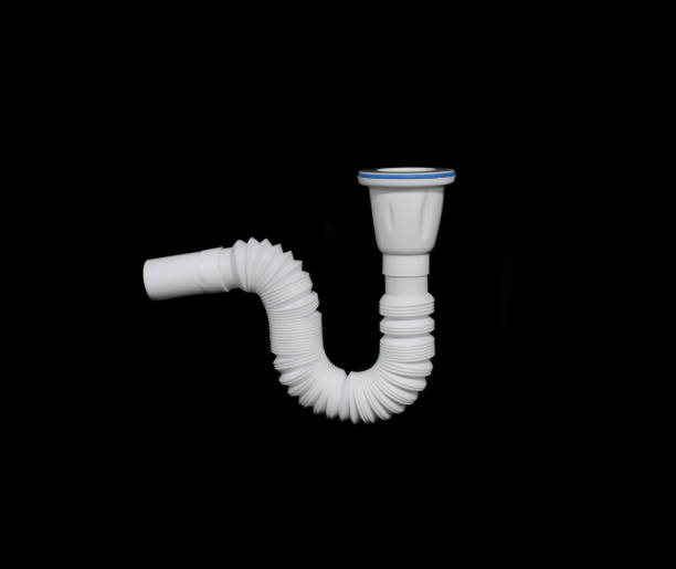 istock White sink pipe isolated on black background. Plastic sink water drain pipe plumbing tool. 1196308456