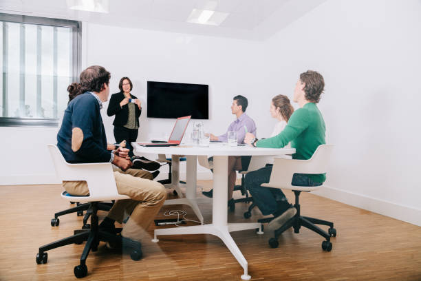 istock Group of office workers at a meeting around the boss 1196324576