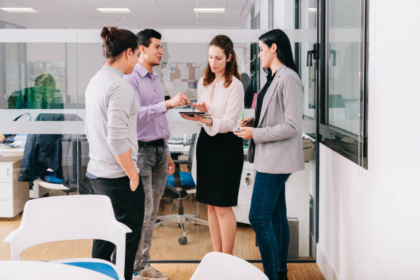 istock Group of office workers at a meeting around the boss 1196324609