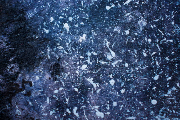 istock Splashes of white paint on a dark blue background 1196325381