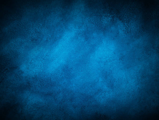 istock Dark blue marble or cracked concrete background with some light in the center 1196325396