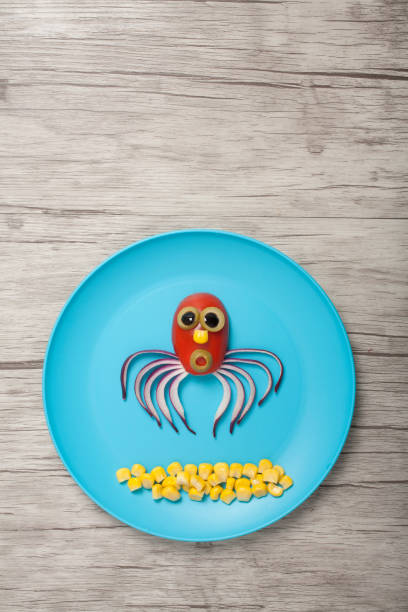 istock Funny vegetable jellyfish made on blue plate and board 1196328165