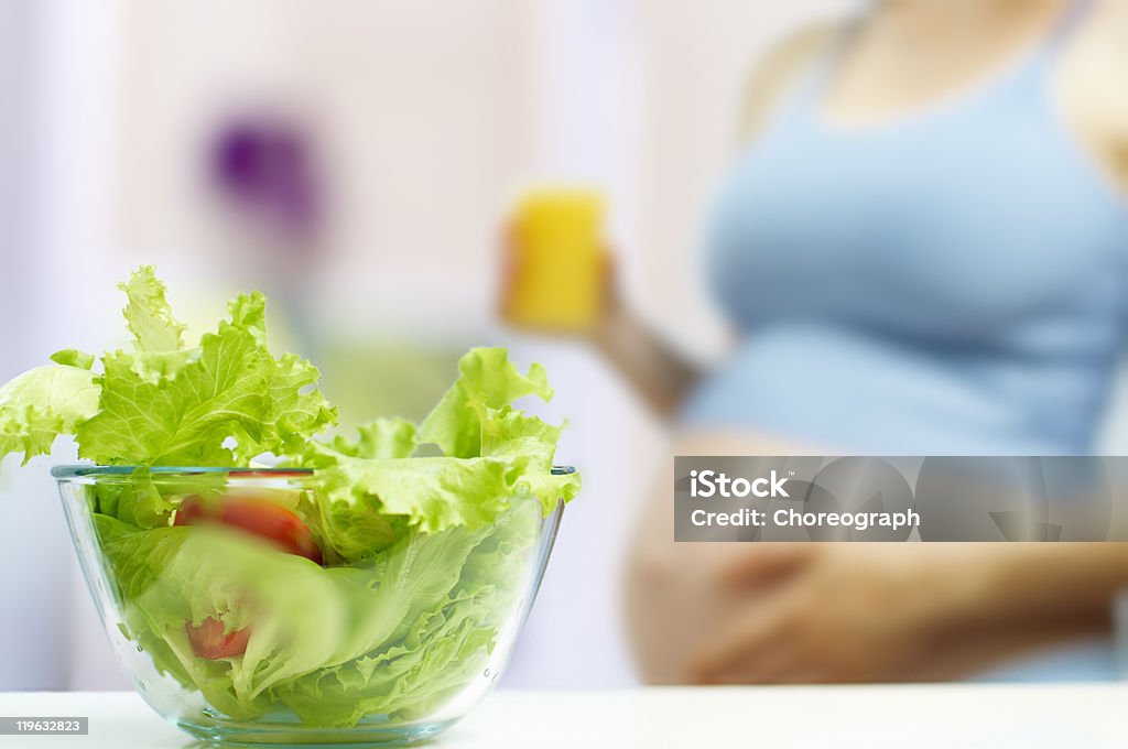 Pregnant woman eating healthy food A beautiful pregnancy woman eating healthy food Adult Stock Photo