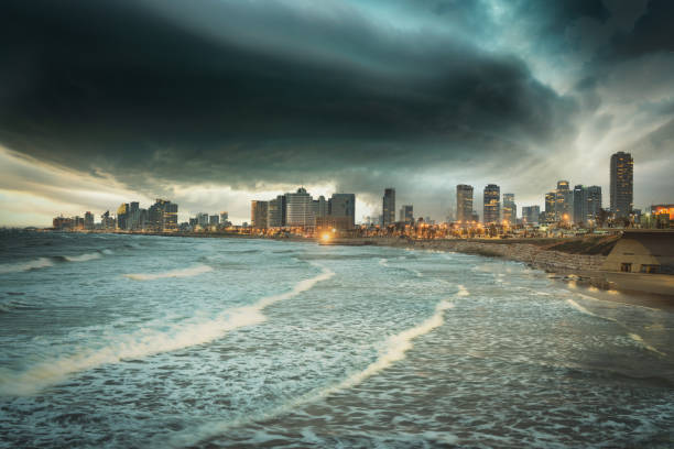Dramatic Thunderstorm Sunset Cloudscape over the illuminated Tel Aviv Mediterranean Sea Waterfront City Skyline. Edited Image, Masked. Tel Aviv, Israel, Middle East