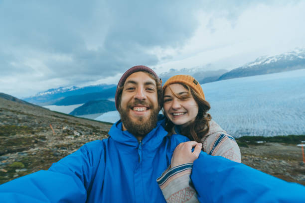 Selfie of couple on the background of  Grey glacier in Torres del Paine National Park Selfie of young Caucasian heterosexual couple on the background of  Grey glacier in Torres del Paine National Park chile tourist stock pictures, royalty-free photos & images