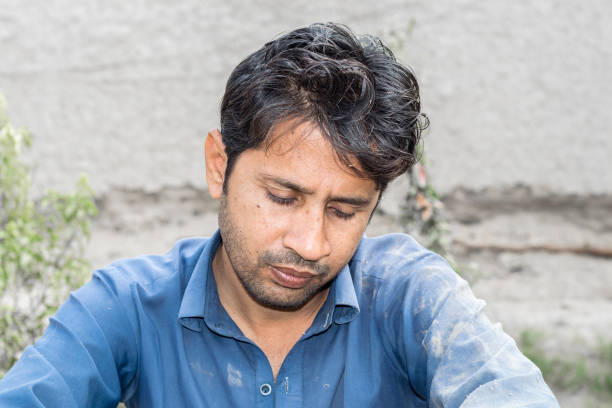 istock a young man is sitting alone and feeling lonely 1196330080