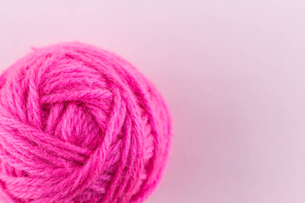 istock yarn color pink on pink background. 1196333727