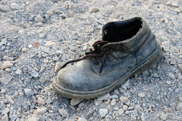 istock Old and dirty shoe left on the garbage 1196336676