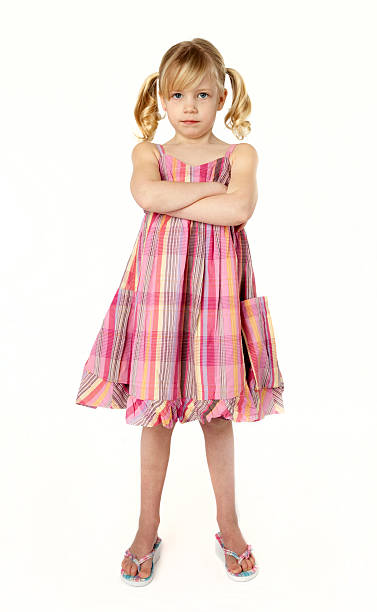 Little Brat Full length studio photo of 5 year old girl with arms crossed, looking defiantly at camera. sad child standing stock pictures, royalty-free photos & images
