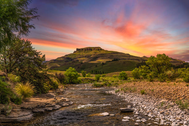 Drakensberg valley and a river running through it Drakensberg valley and a river running through it during sunset drakensberg mountain range stock pictures, royalty-free photos & images