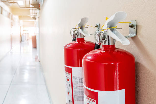 istock Close-Up Of Red Fire Extinguisher At Corridor 1196345870