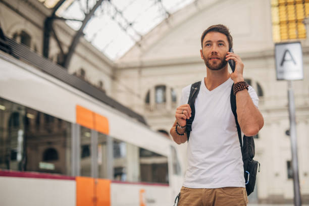 istock Man talking on mobile on train station in city 1196346410