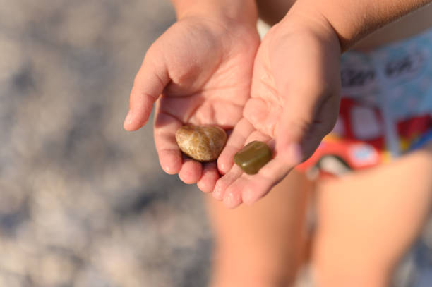 background, beach, beautiful, beauty, bokeh, boy, child, childhood, children, closeup, color, concept, day, family, fingers, fun, game, girl, golden, hands, happiness, happy, holding, hour, kid, kids, little, natural, nature, ocean, outdoor, pebbles, people, play, rock, sea, skin, stone, stones, summer, time, top view, two, vacation, water, wet, wrinkle, wrinkled, wrinkling, young