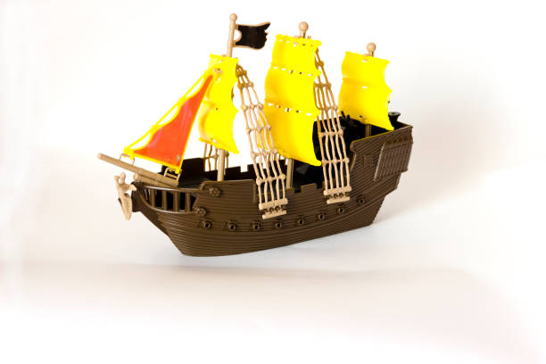 pictured in the photo Toy wooden ship circling isolated on white background
