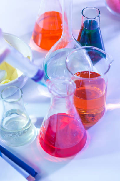 istock Bunch of Colorful Liquid Chemicals in Flasks Placed in Lab.Vertical Image Composition 1196349228