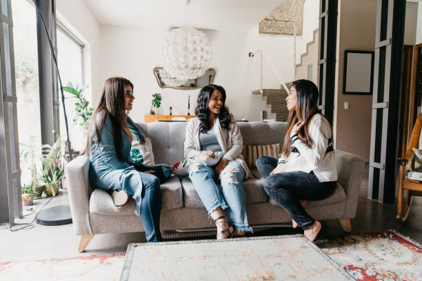 istock Three friends talking together at home 1196352197