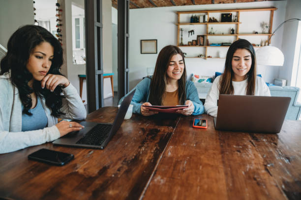 istock Three young adult women working together 1196352249