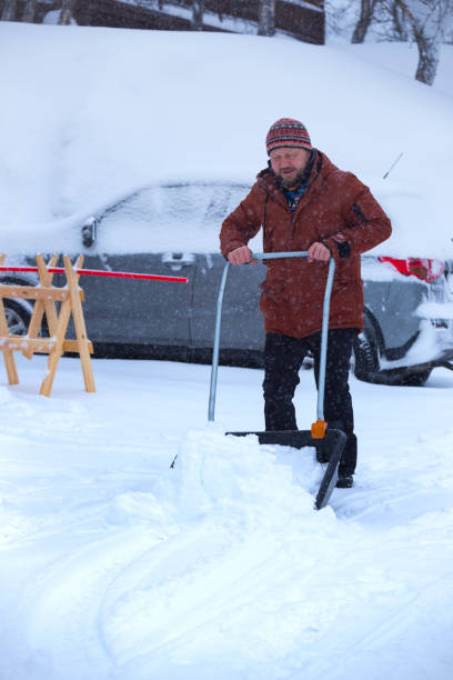 istock winter and snowfall. man cleans snow with a shovel